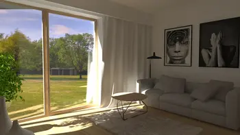 Wnętrze salonu z jasną sofą, obrazami i dużym oknem