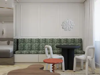 Wnętrze jadalni z zieloną kanapą, czarnym stołem i lampą w stylu art deco i tradycyjnym.