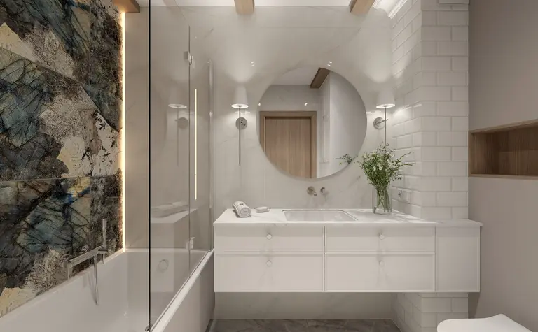 Wnętrze łazienki z białą ceramiką, drewnianymi detalami oraz eleganckim lustrem.