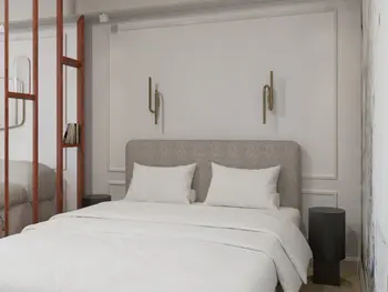 Sypialnia w stylu art deco i tradycyjnym z białym łóżkiem i dekoracyjną ścianą.
