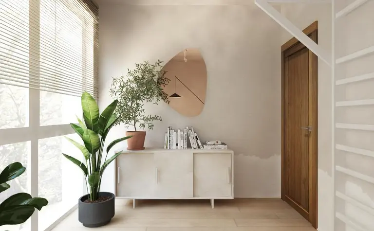 Wnętrze w stylach boho i japandi z białą komodą i roślinami.