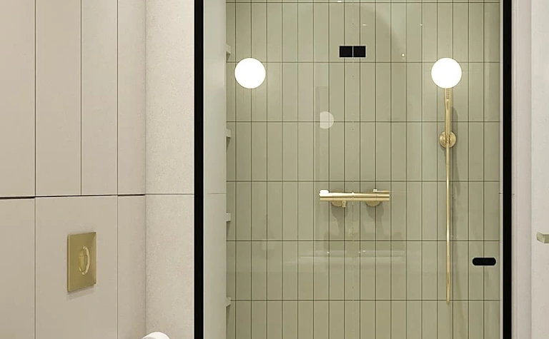 Nowoczesna łazienka z szarymi płytkami, złotymi akcentami i białym WC