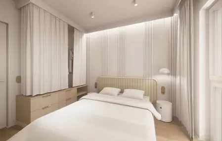 Sypialnia w stylu japandi z minimalistycznym wystrojem, białymi i drewnianymi elementami.