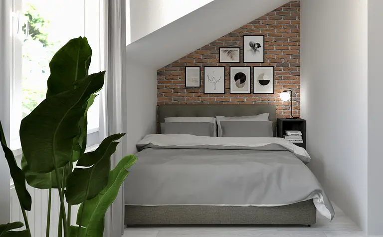 Sypialnia w stylu industrialnym i soft minimalizm z ceglaną ścianą i szarym łóżkiem.
