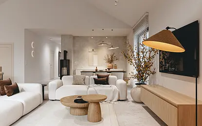 Wnętrze salonu w stylu skandynawskim z białymi meblami i drewnianymi akcentami.