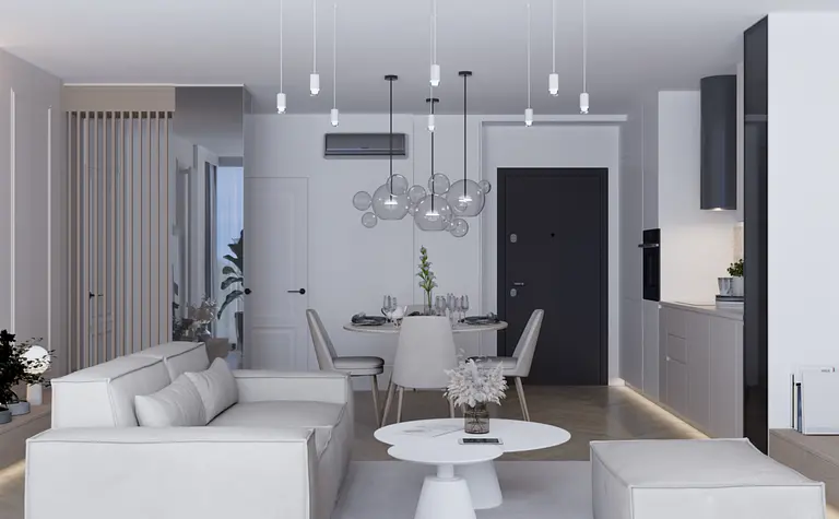 Nowoczesne wnętrze salonu z białą sofą, szarymi akcentami oraz minimalistycznym oświetleniem.