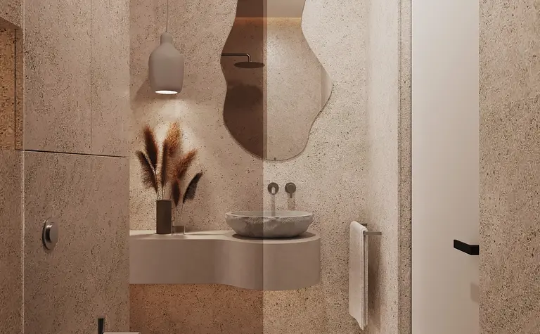 Minimalistyczna łazienka w stylu japandi z beżowymi ścianami i nowoczesnym lustrem.