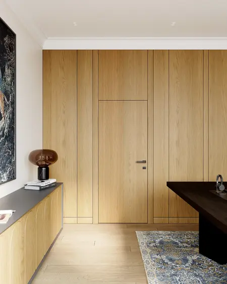 Nowoczesne wnętrze z drewnianymi ścianami i eleganckim oświetleniem w stylu quiet luxury.