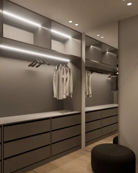 Garderoba z minimalistycznym designem, nowoczesnymi meblami i oświetleniem.