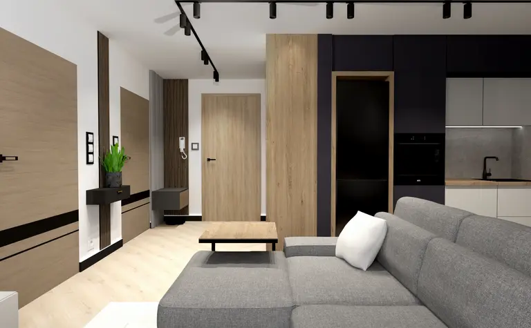 Wnętrze z szarym sofą, drewnianymi drzwiami i nowoczesną kuchnią w stylu industrialnym.