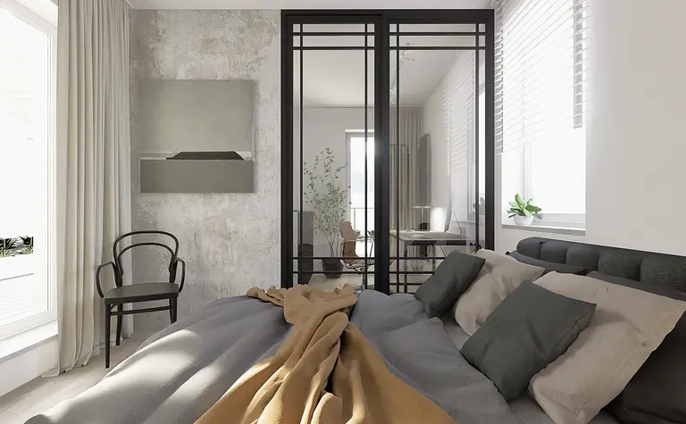 Sypialnia w stylu industrialnym z minimalistycznym łóżkiem i biurkiem.