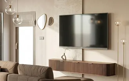 Wnętrze salonu z brązową sofą, telewizorem i minimalistycznym oświetleniem.