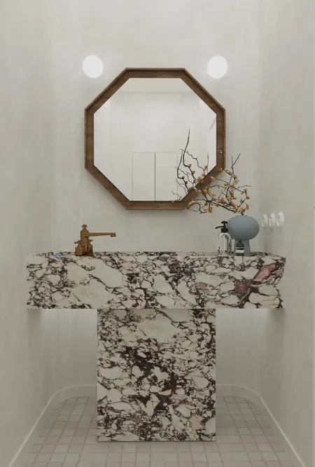 Nowoczesna łazienka z marmurową umywalką, lustrem w stylu art deco i minimalistycznymi akcentami.