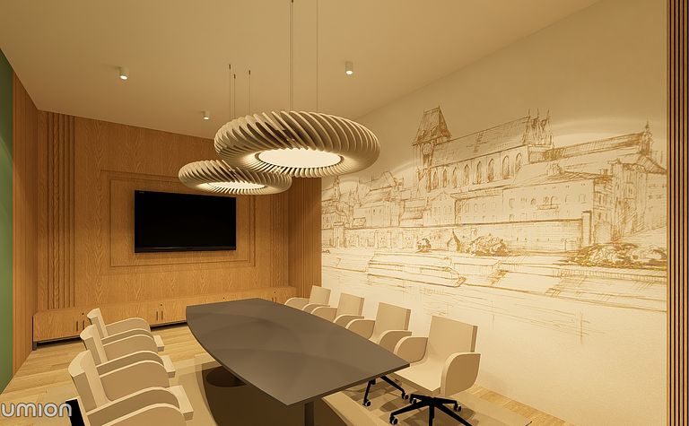 Sala konferencyjna z drewnianymi elementami, dużym stołem i nowoczesnym oświetleniem.