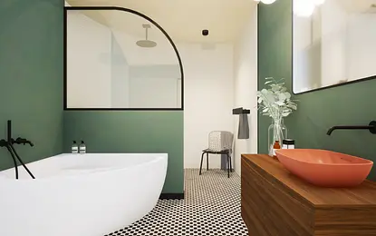 Wnętrze łazienki w stylu art deco i vintage z zielonymi ścianami i białą wanną.