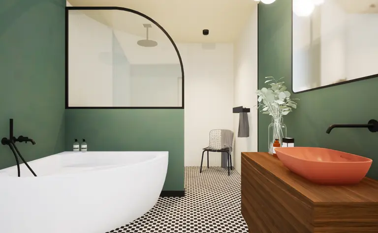 Wnętrze łazienki w stylu art deco i vintage z zielonymi ścianami i białą wanną.
