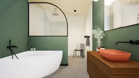 Wnętrze łazienki w stylu art deco i vintage z zielonymi ścianami i białą wanną.