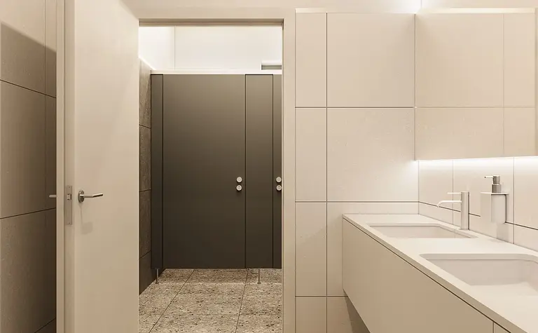 Wnętrze nowoczesnej łazienki z minimalistycznym designem i szarymi płytkami.