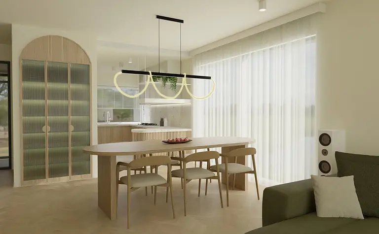 Jasna jadalnia z owalnym stołem drewnianym, czterema krzesłami, designerską lampą sufitową w kształcie pętli oraz szafą o zaokrąglonych drzwiach.
