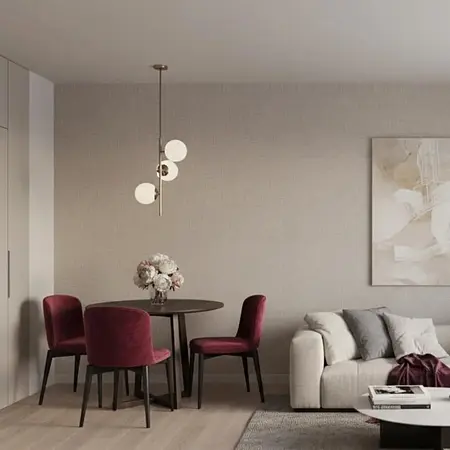 Wnętrze jadalni z okrągłym stołem, bordowymi krzesłami i nowoczesnym oświetleniem w stylu minimaluxe.