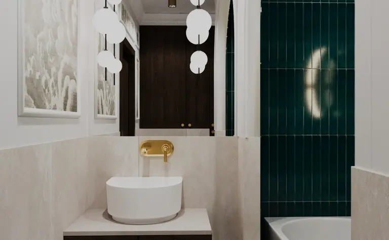 Łazienka w stylu art deco i vintage z białą umywalką, ciemnym blatem i zielonymi kafelkami.