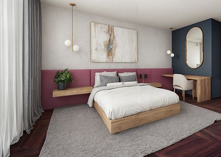Sypialnia w stylu art deco z drewnianym łóżkiem, różowymi ścianami i nowoczesnym biurkiem.