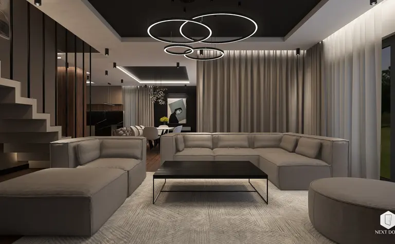 Wnętrze salonu z szaro-beżową sofą, czarnym stolikiem i zasłonami, styl quiet luxury.