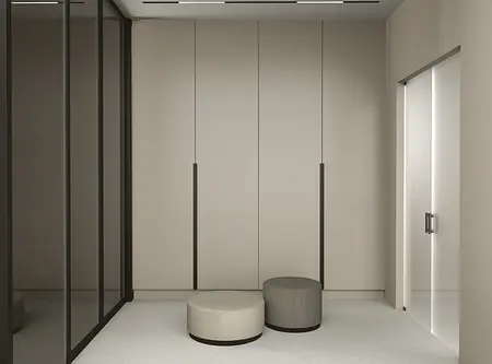 Nowoczesny przedpokój z szafą, szarym i beżowym siedziskiem, w stylu quiet luxury.