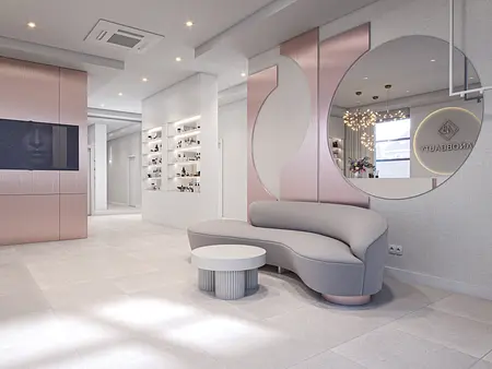 Nowoczesne wnętrze salonu z minimalistycznym designem, szaro-różową sofą i oświetleniem.