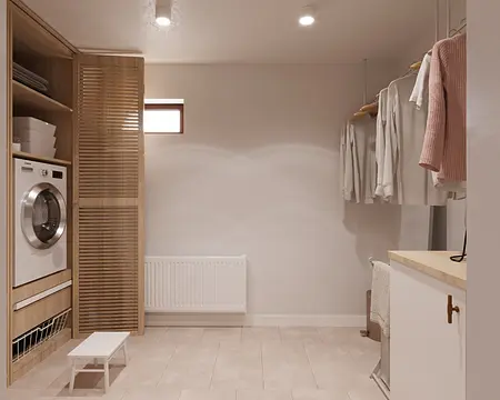 Pralnia w stylu minimalistycznym z drewnianymi meblami i pralką.