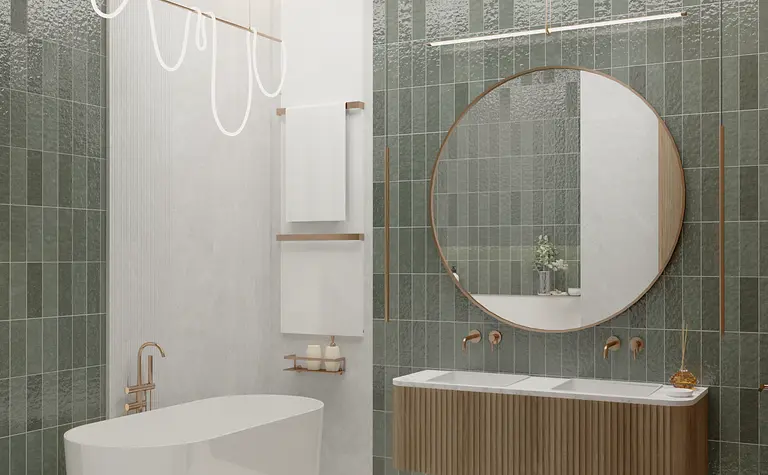 Nowoczesna łazienka z zielonymi płytkami, wanną i okrągłym lustrem w stylach art deco i vintage.