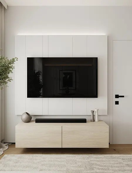 Nowoczesny salon z szarymi ścianami, białym telewizorem i minimalistycznymi akcentami.