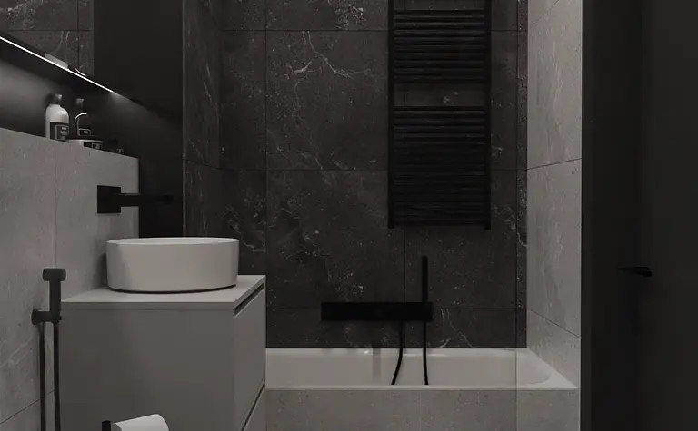 Wnętrze minimalistycznej łazienki z czarnymi i szarymi elementami.