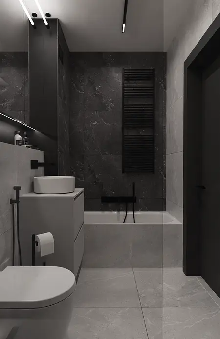 Wnętrze minimalistycznej łazienki z czarnymi i szarymi elementami.