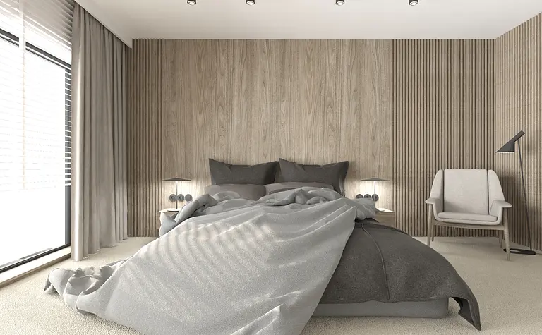 Sypialnia w stylu industrialnym i minimalistycznym z drewnianą ścianą i szarym łóżkiem.