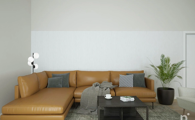 Wnętrze salonu w stylu skandynawskim z brązową sofą, czarnym stolikiem i rośliną.