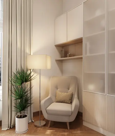 Wnętrze w stylu art deco z jasnym fotelem, rośliną i lampą.