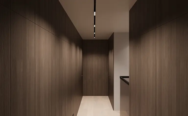 Przedpokój w minimalistycznym stylu z brązowymi ścianami i jasną podłogą.