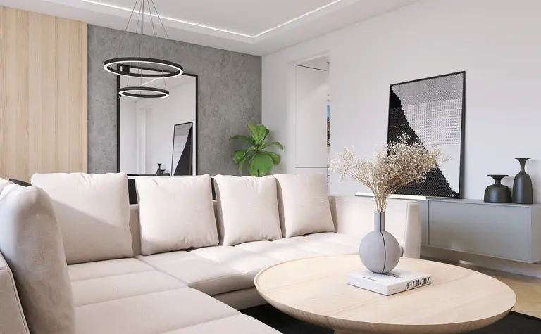 Nowoczesny salon z beżową sofą, okrągłym stołem i rośliną.