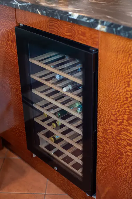 Kuchnia z drewnianą lodówką na wino, elementy vintage i współczesne