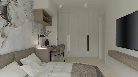 Wnętrze sypialni z szarymi meblami, drewnianym biurkiem i kwiatowym akcentem.