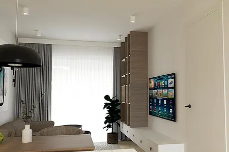 Wnętrze salonu z jasnymi ścianami, drewnianymi meblami i nowoczesnym oświetleniem.