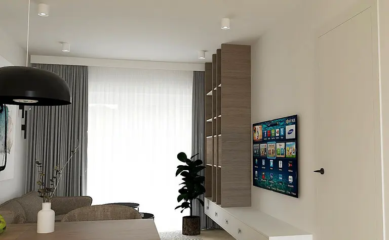 Wnętrze salonu z jasnymi ścianami, drewnianymi meblami i nowoczesnym oświetleniem.