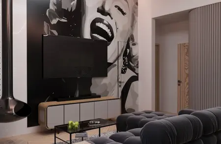 Wnętrze salonu w stylu eklektycznym i minimalistycznym z czarną sofą i muralem.