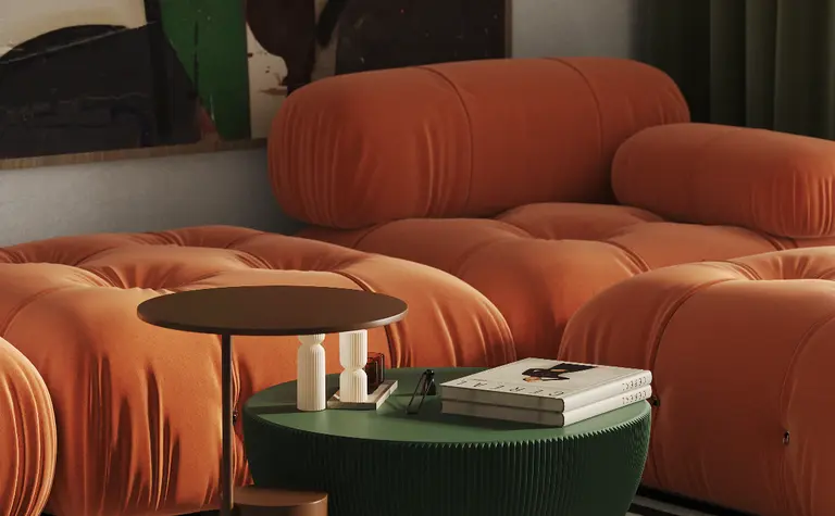 Nowoczesny salon w stylu art deco z pomarańczowymi sofami i zielonym stolikiem.