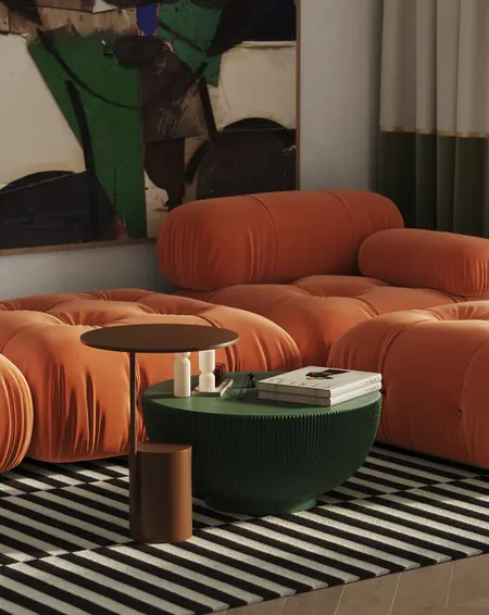 Nowoczesny salon w stylu art deco z pomarańczowymi sofami i zielonym stolikiem.
