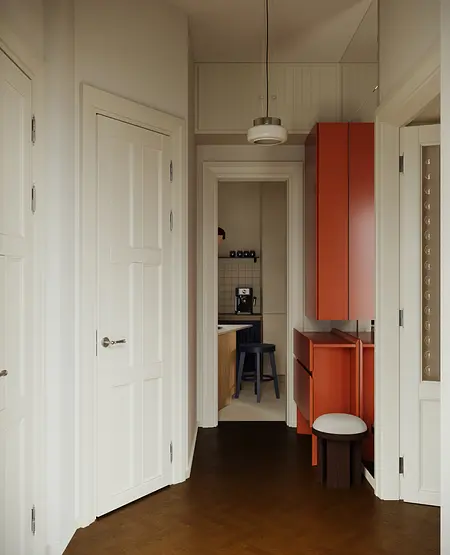 Przedpokój z tradycyjnymi i soft minimalizm meblami w odcieniach bieli i pomarańczy.