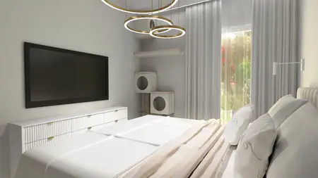 Sypialnia z białym łóżkiem, telewizorem i złotymi lampami.