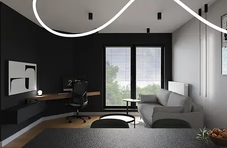 Minimalistyczne wnętrze biura z szarym biurkiem i czarną kanapą.