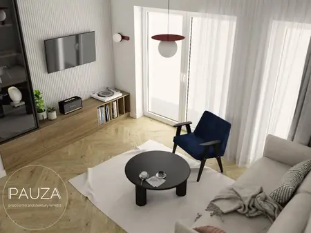 Wnętrze nowoczesnego salonu z niebieskim fotelem, czarnym stolikiem i drewnianą podłogą.